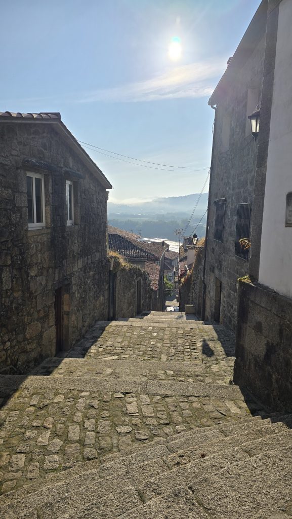 Die Gassen von Tui mit Kopfsteinpflaster, alten Steinhäusern und einem Blick über das Tal