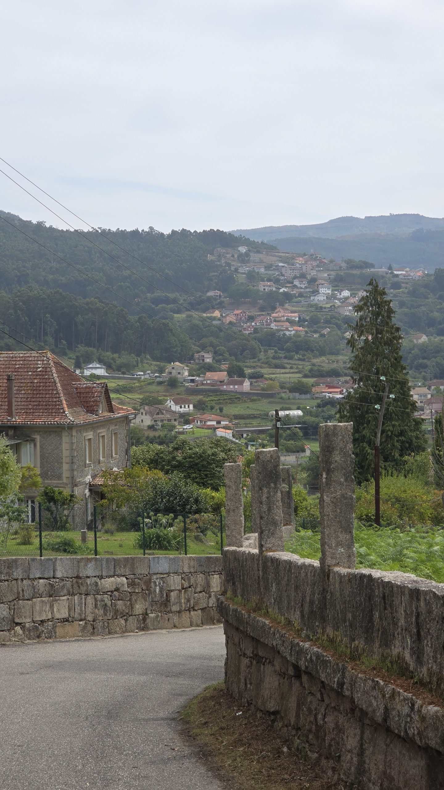 Blick auf das Tal der Stadt Arcade. Grüne Hänge und kleine weiße Gebäude mit roten Dächern