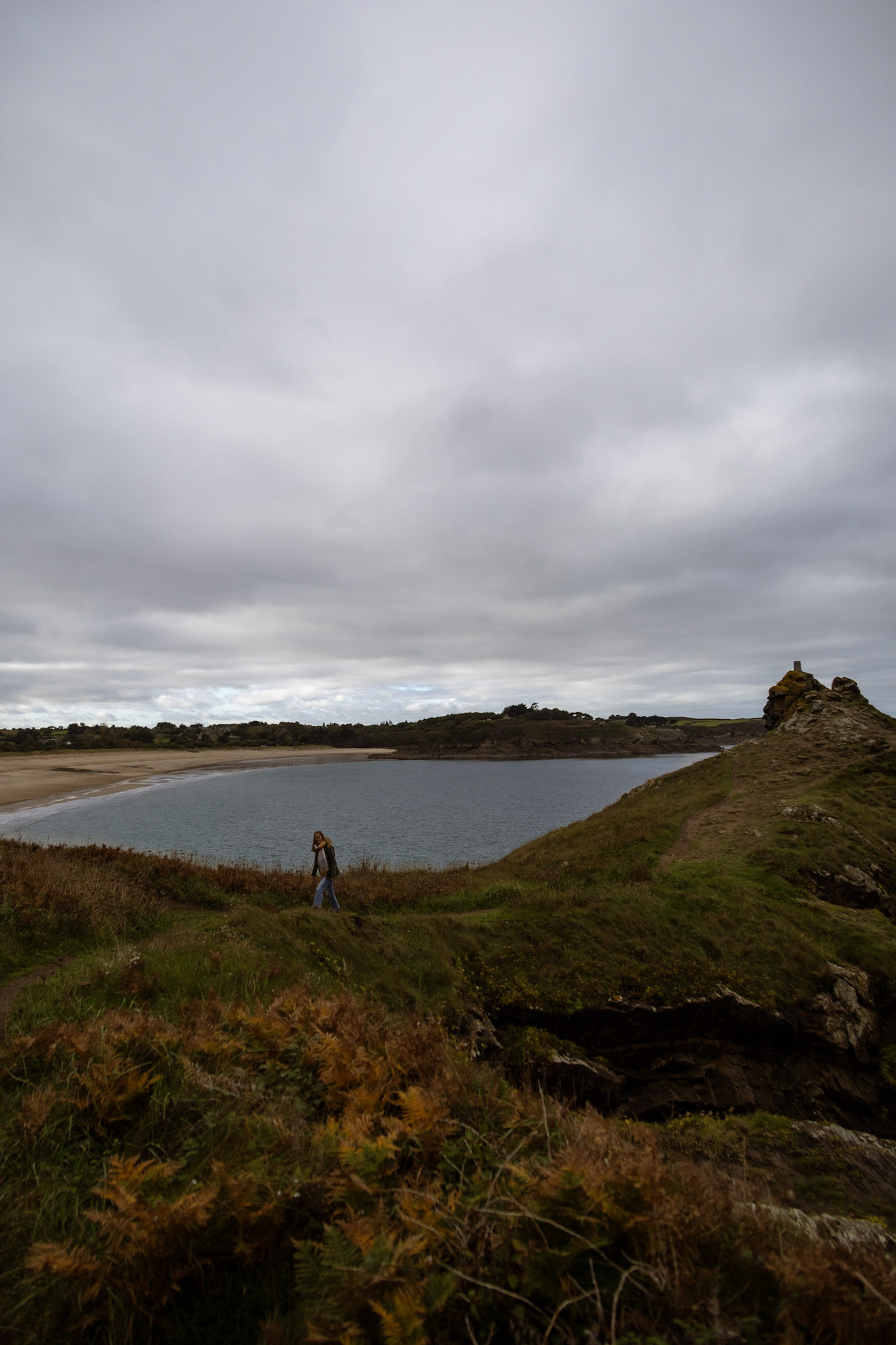 Wanderweg Zöllnerpfad entlang der bretonischen Küstenlinie mit einen Sandstrand im Hintergrund